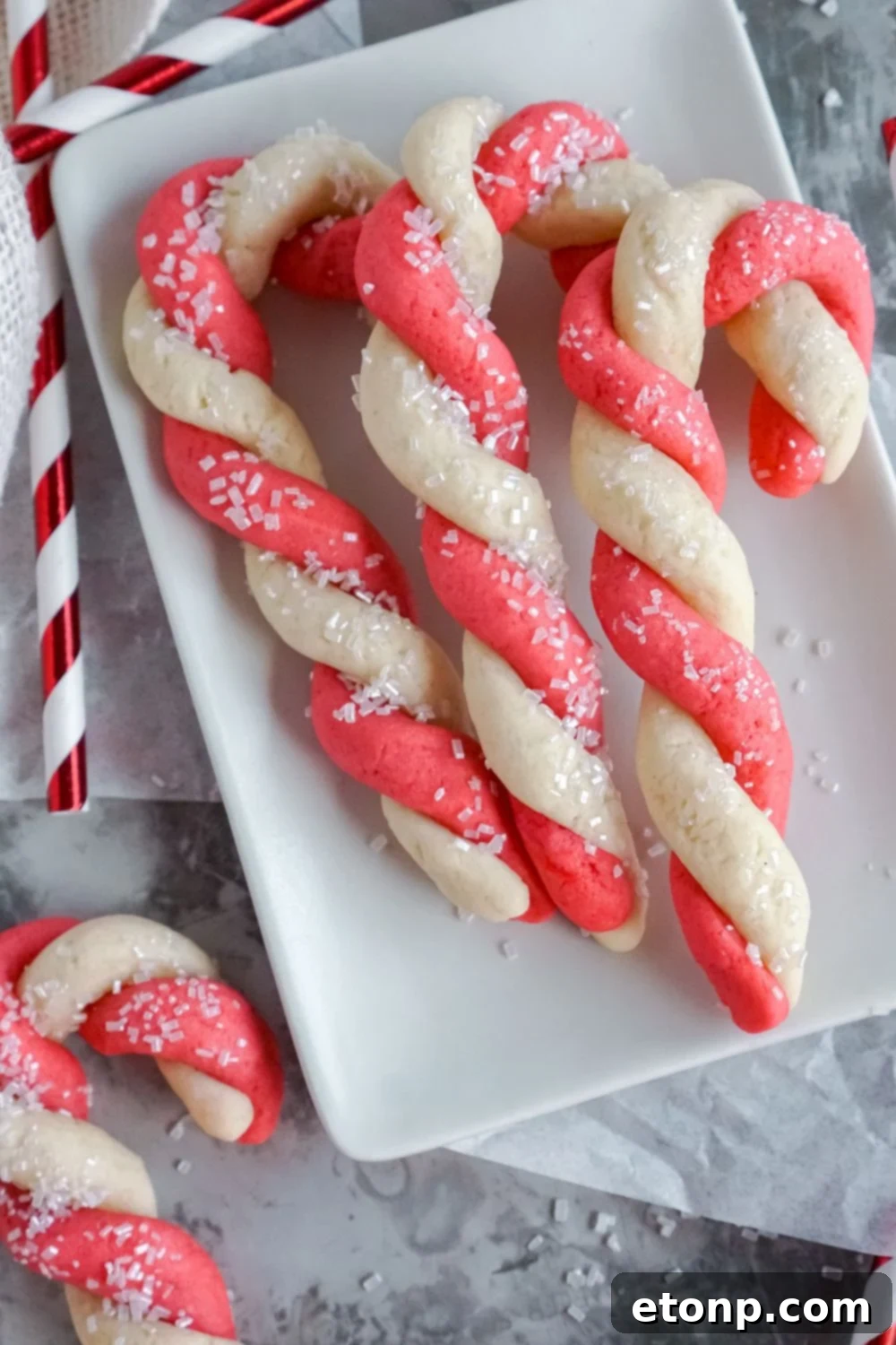 Sweet Peppermint Swirls 14 Candy Cane Cookies artfully arranged on a white plate