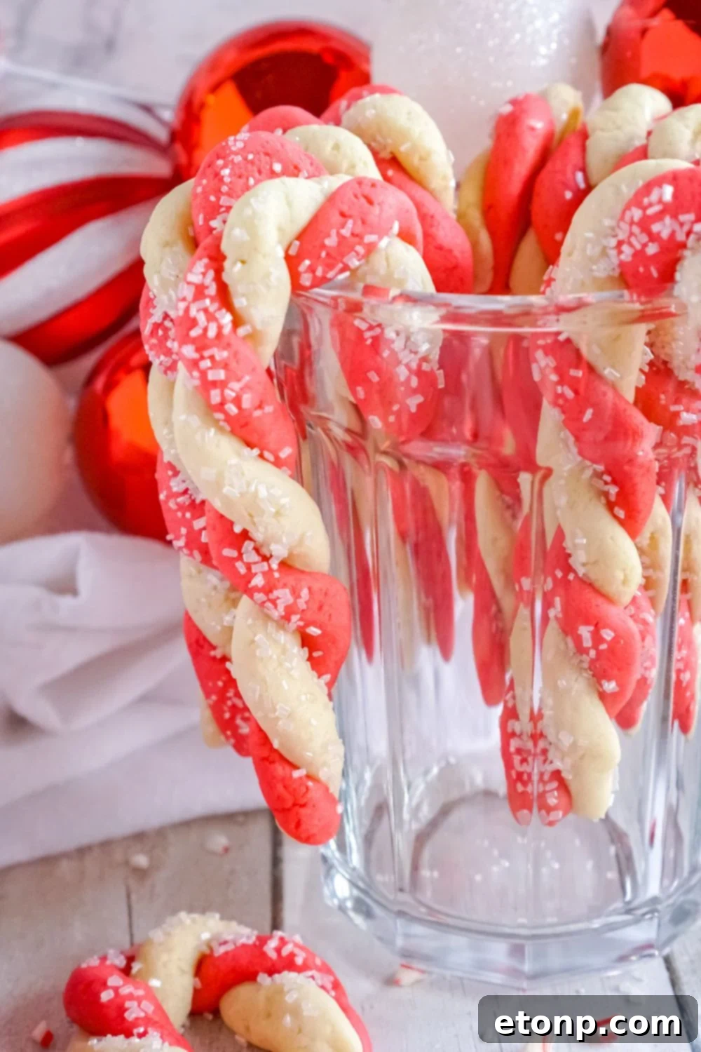 Sweet Peppermint Swirls 16 A glass with candy cane cookies hanging delicately on its rim