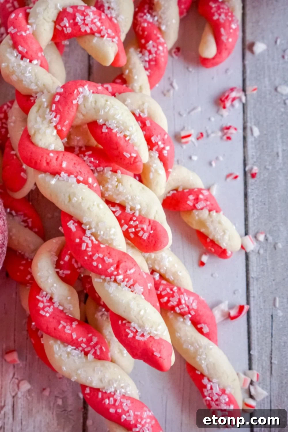 Sweet Peppermint Swirls 17 Candy cane cookies stacked neatly on a tray on a table