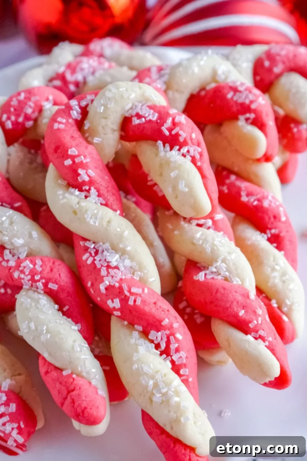 Sweet Peppermint Swirls 18 Candy cane cookies elegantly displayed on a white plate