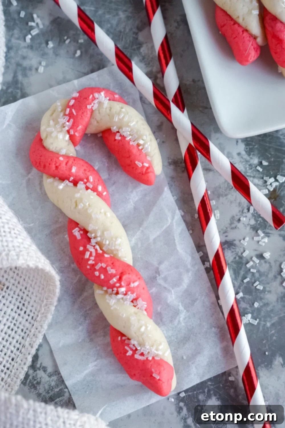Sweet Peppermint Swirls 3 A single Candy Cane Cookie with a festive straw background