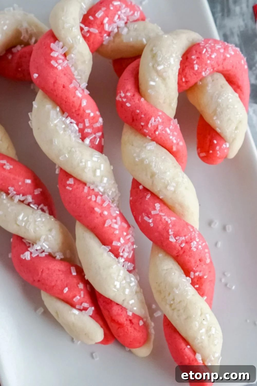 Sweet Peppermint Swirls 21 Christmas cookies baking on a tray in the oven