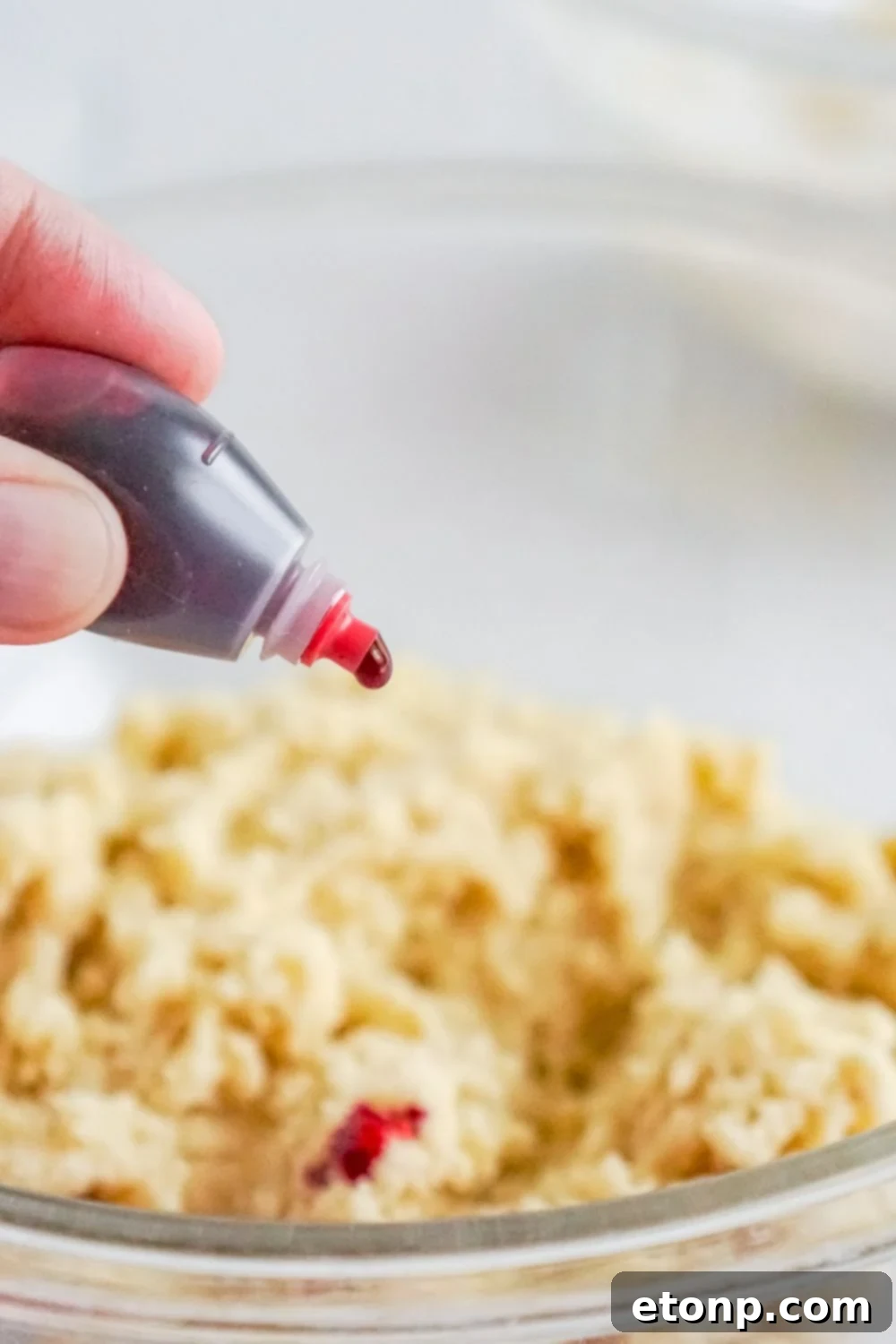 Sweet Peppermint Swirls 8 Red food coloring being dropped into cookie dough