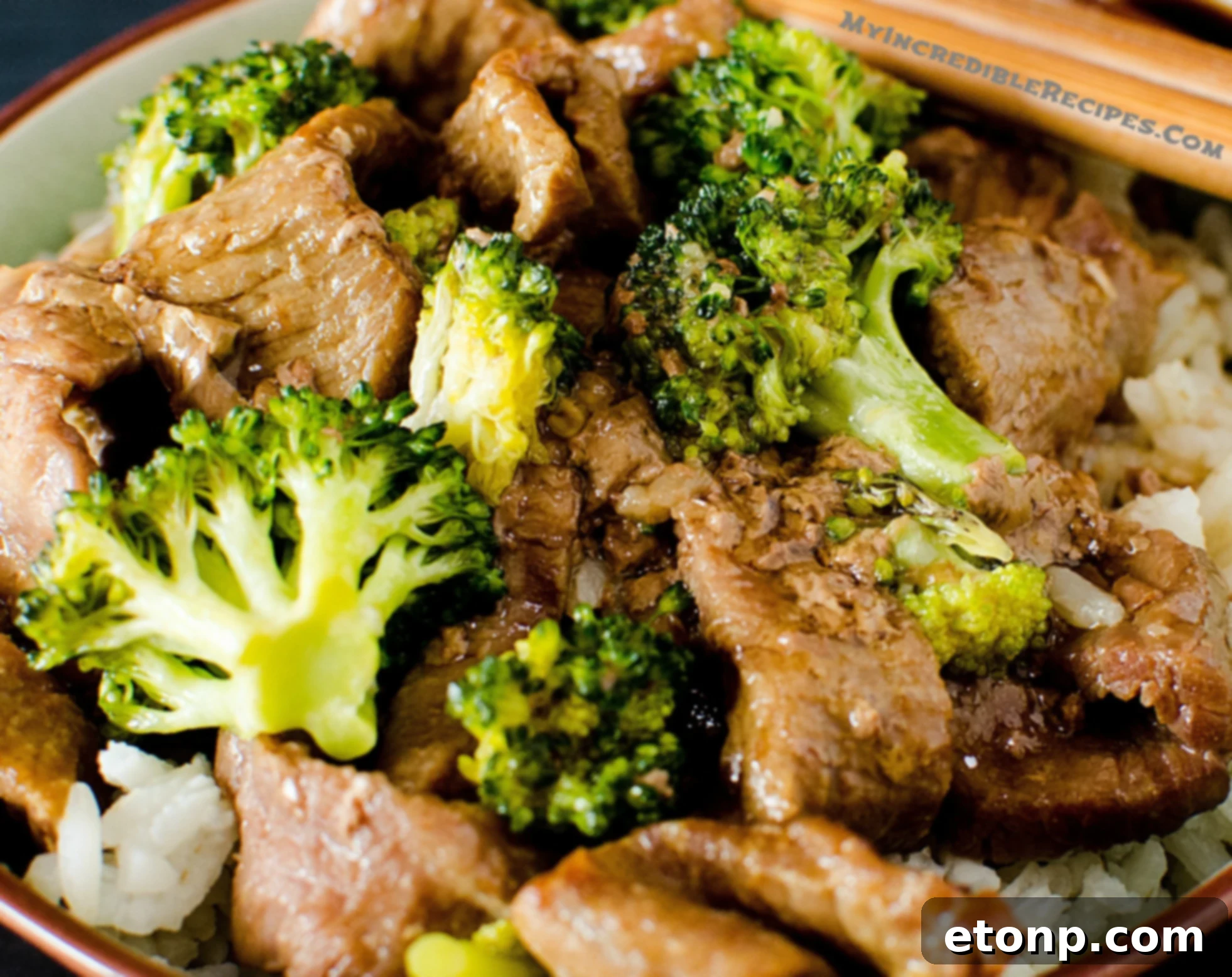 Beef simmering in a rich sauce in the slow cooker