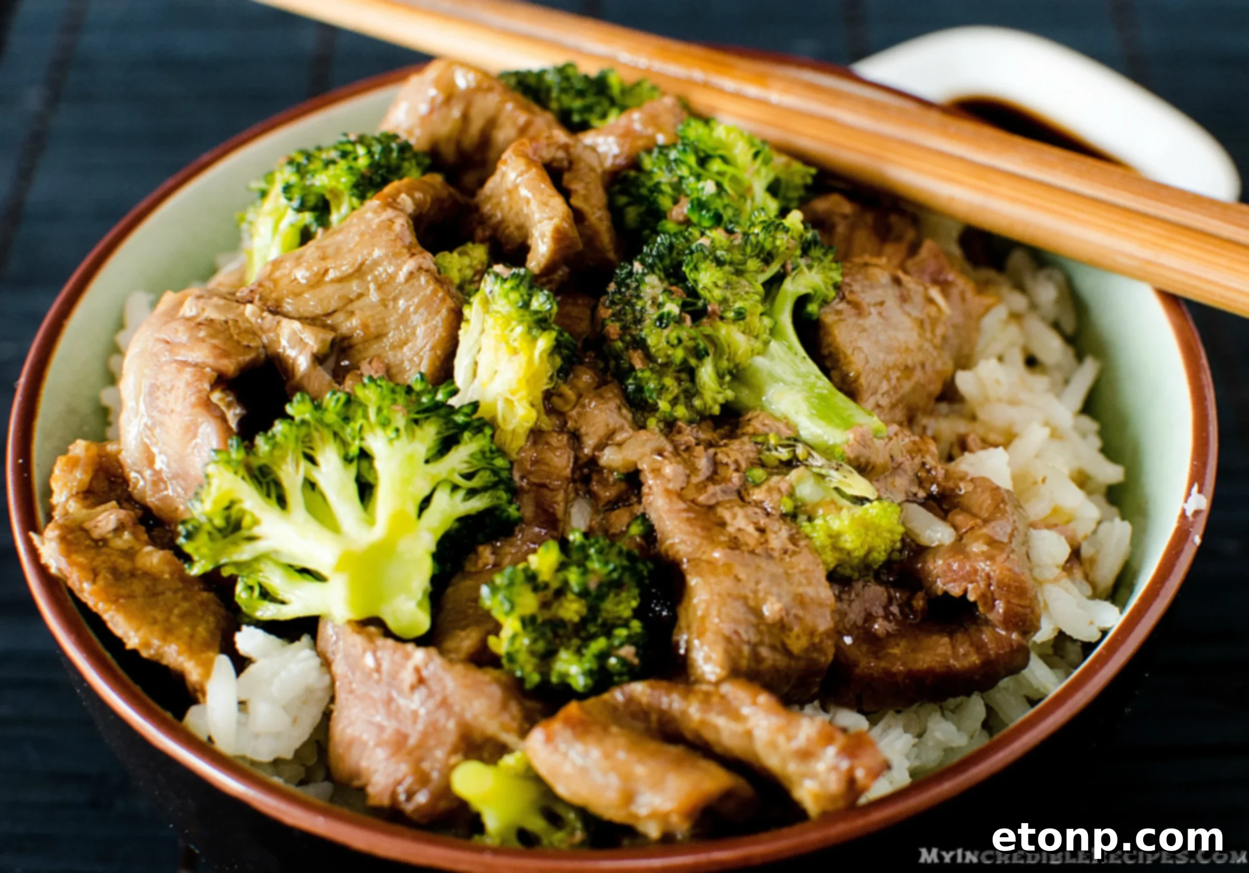 Beef and broccoli with rice, topped with delicious sauce