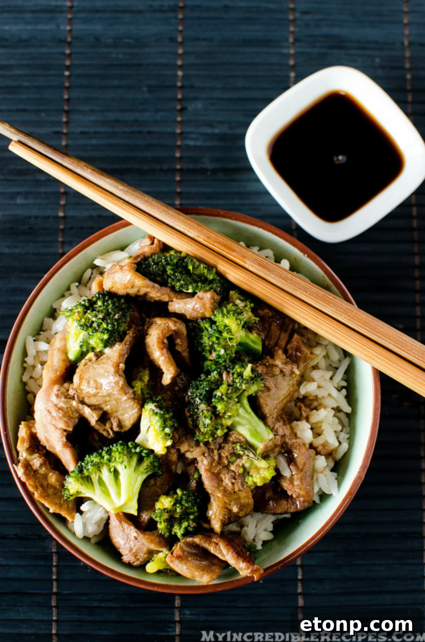 Bowl of Slow Cooker Beef and Broccoli with sauce over rice