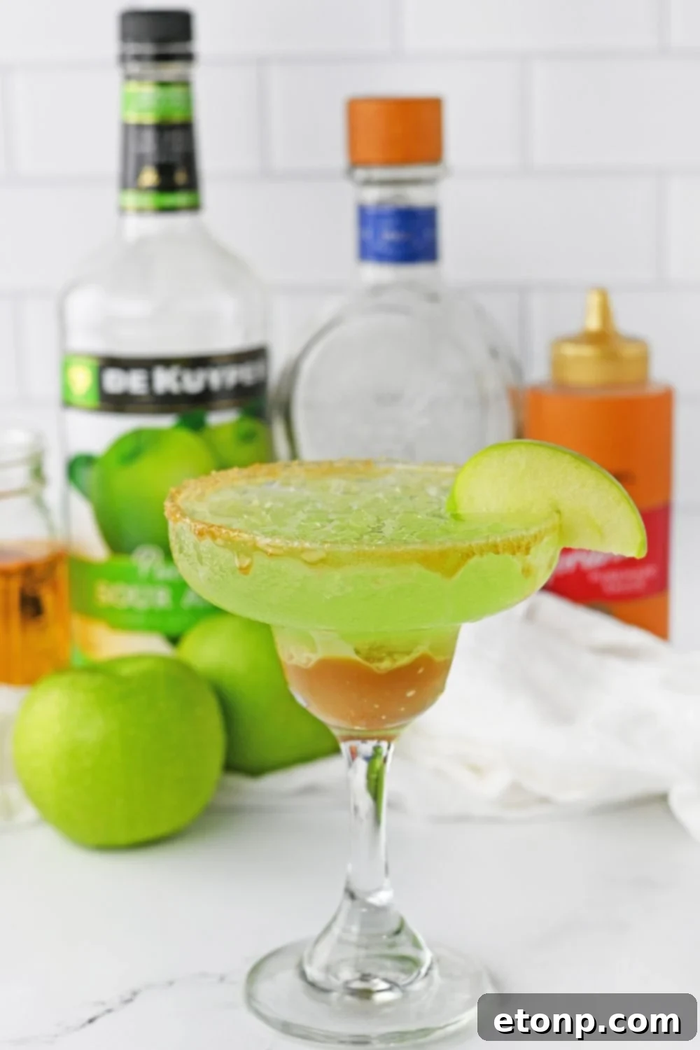 fall margarita on table with ingredients behind it on table