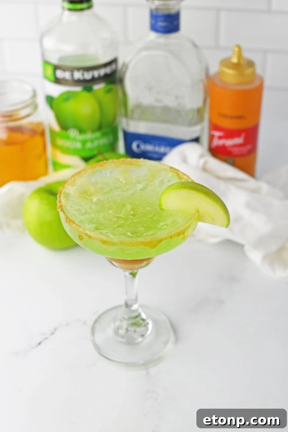 overhead view of margarita with apple wedge on it on table