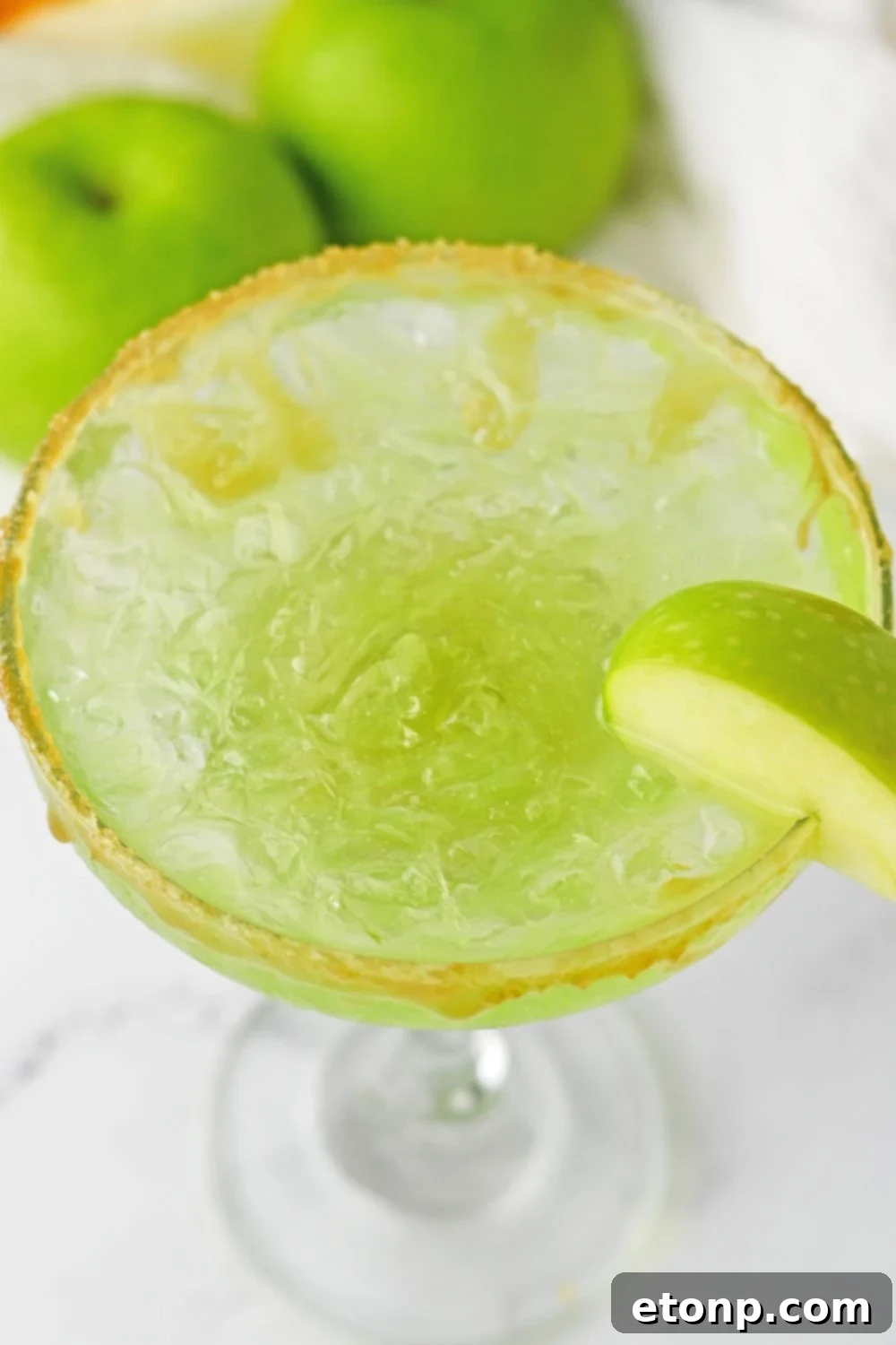 margarita green apple with apple garnished on side of glass