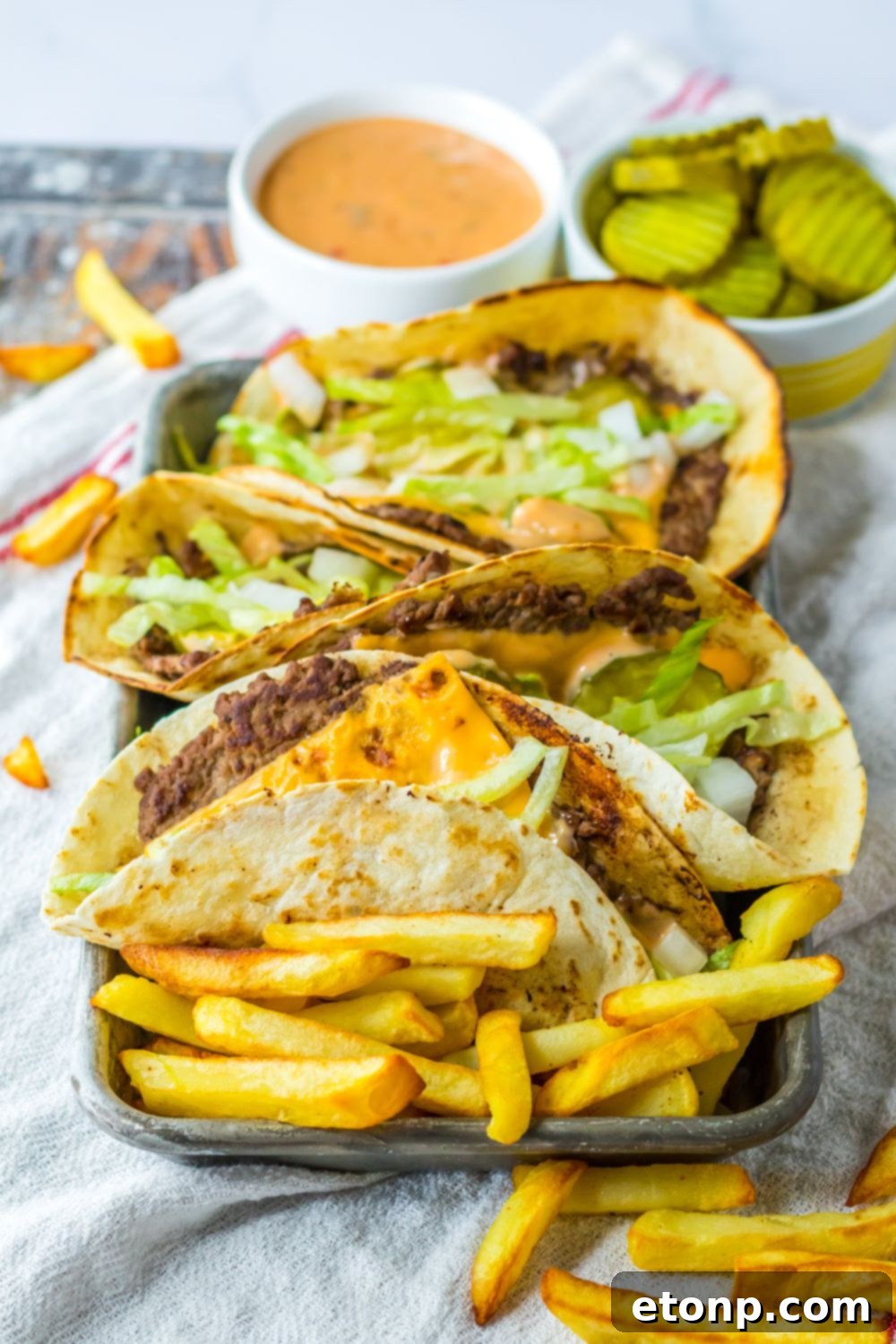 Plate with Big Mac smash tacos and fries around it