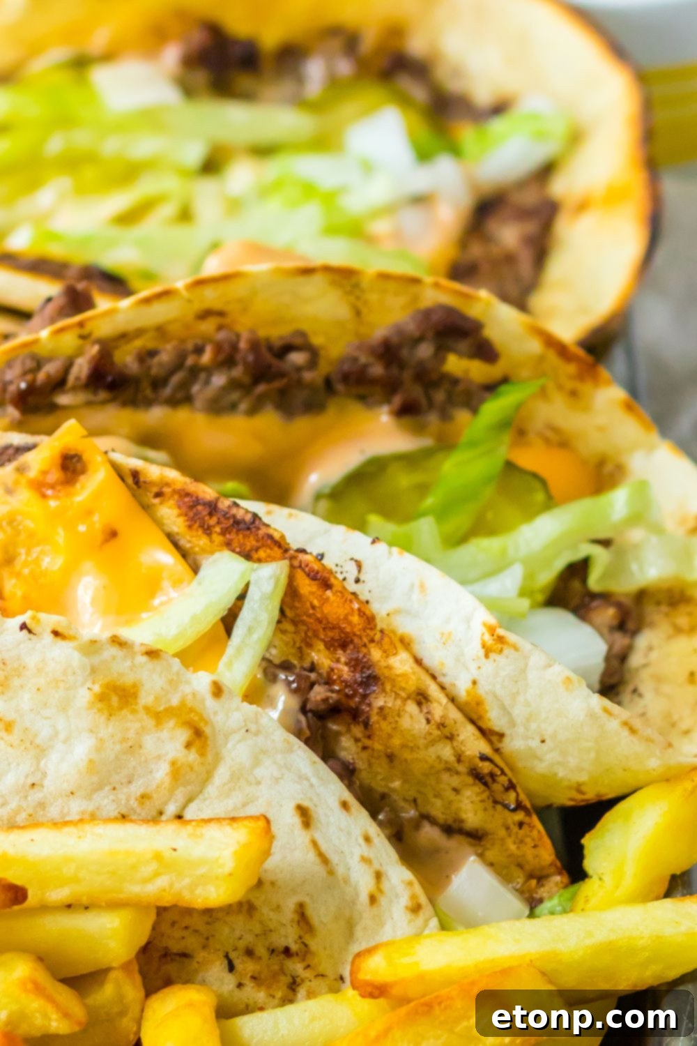 Platter with Big Mac tacos and French fries on a metal tray