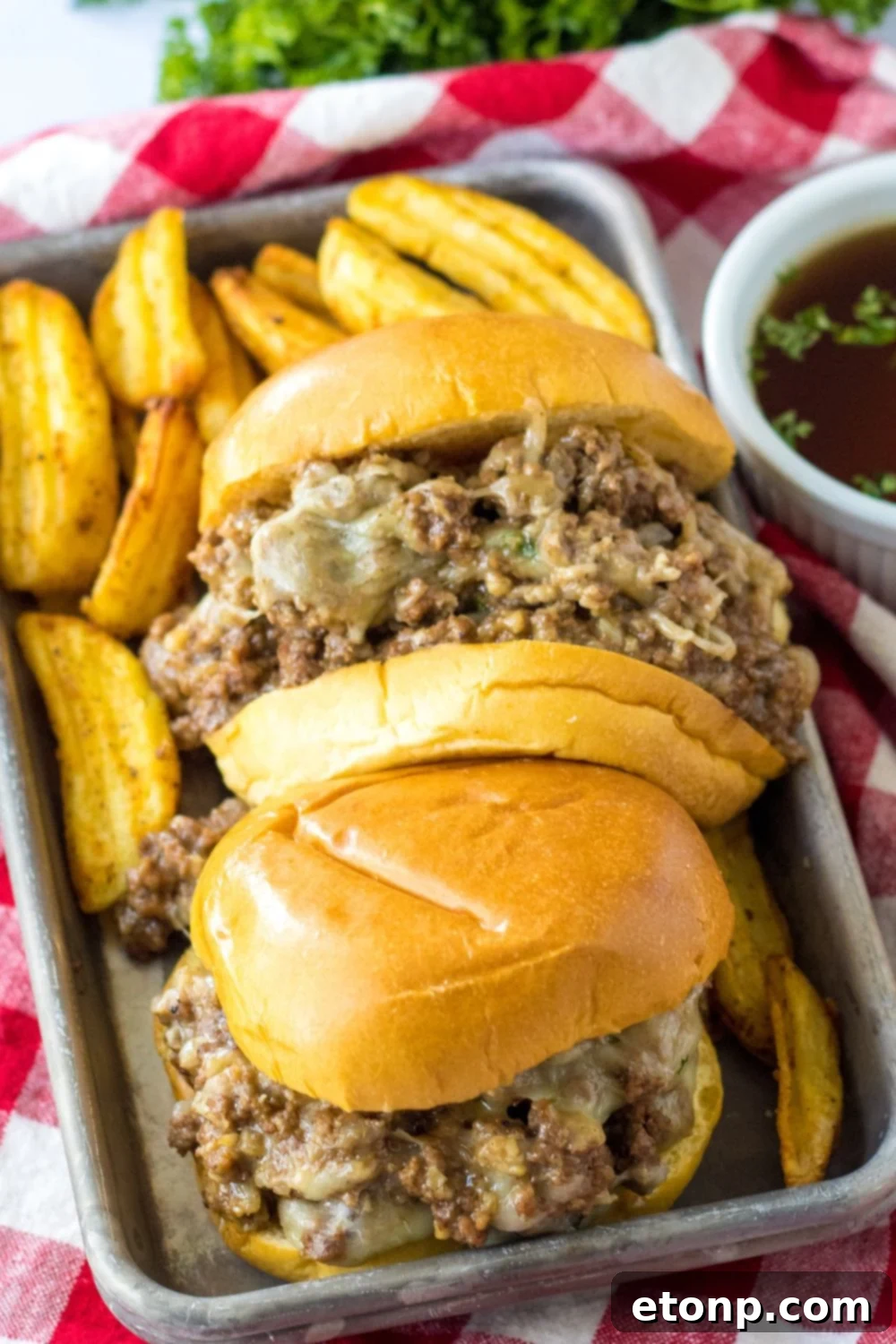 au jus sandwich on a metal tray