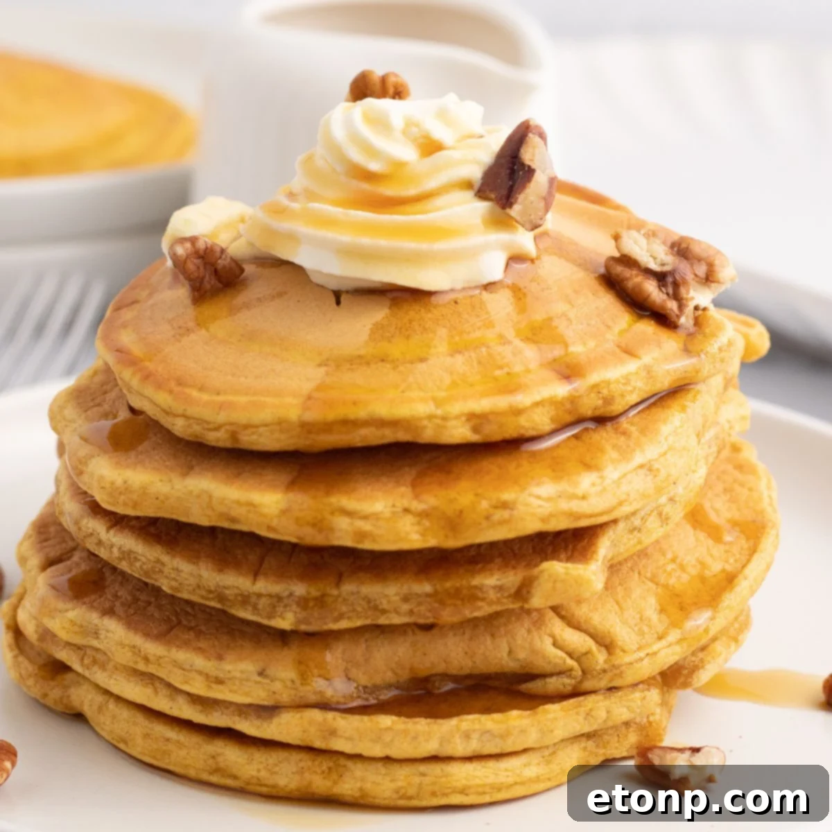 Stacked Pumpkin Spice Pancakes on a plate, ready to be served