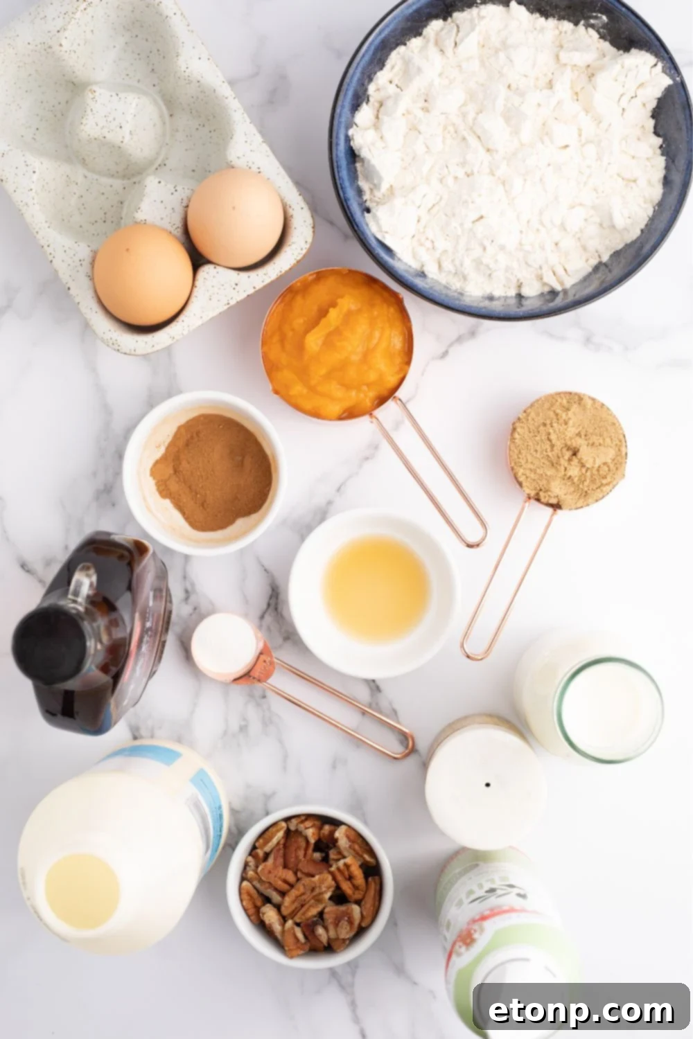 Ingredients for pumpkin spice pancakes laid out on a table