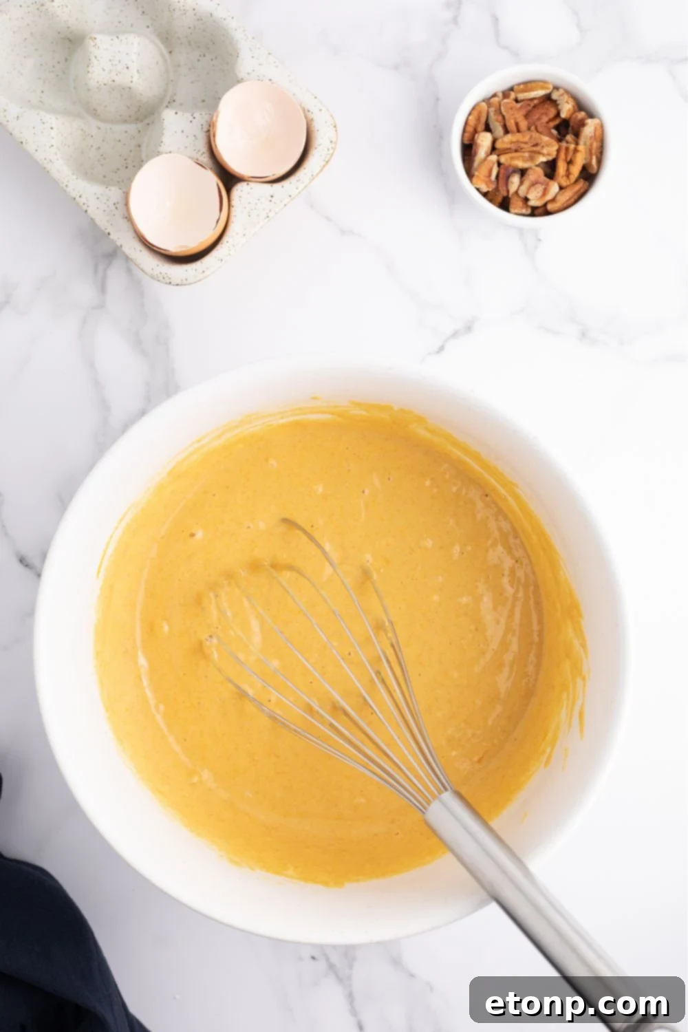 Mixing pumpkin pancake batter in a bowl