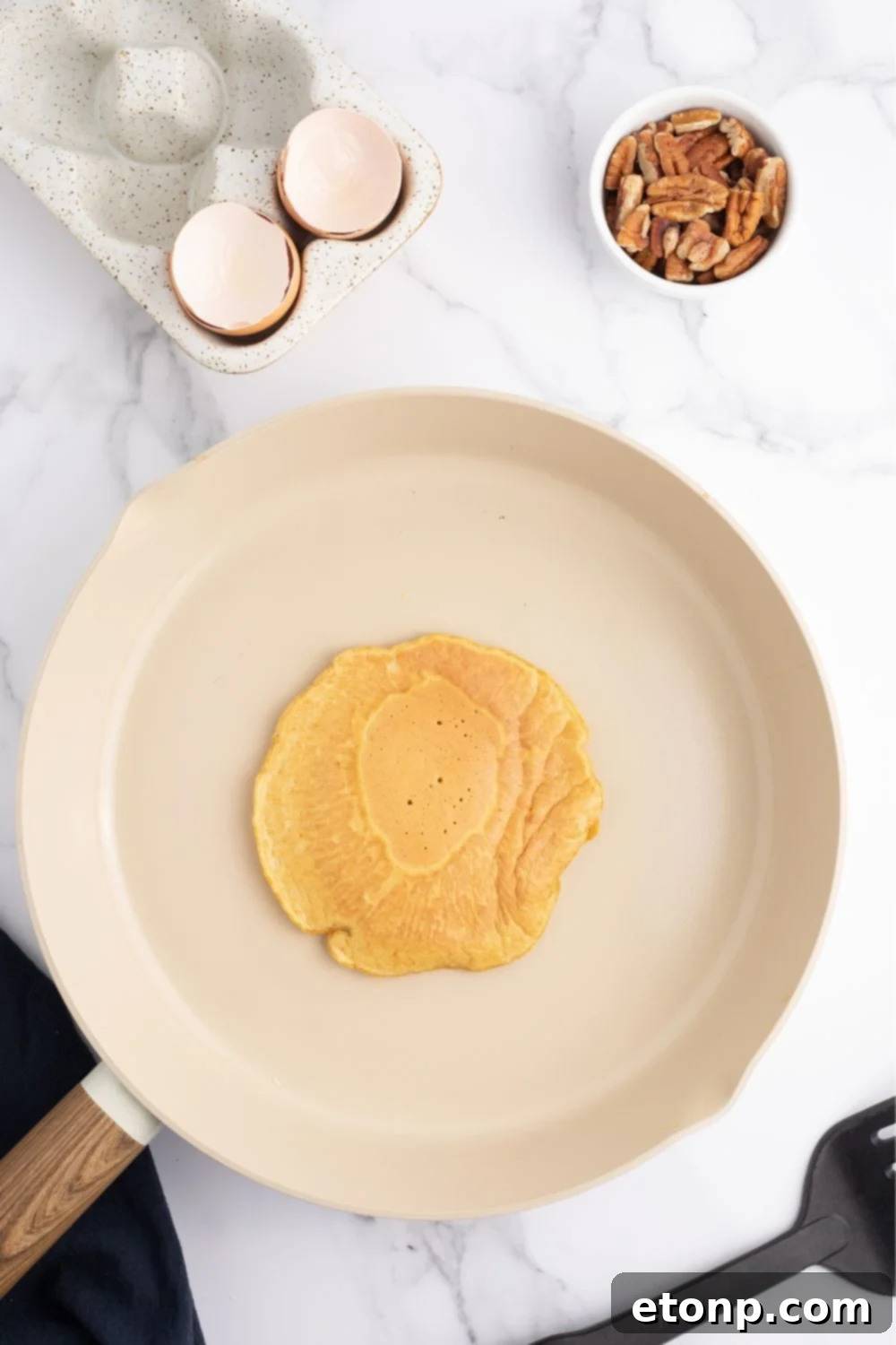 Pancake cooking and bubbling in a skillet