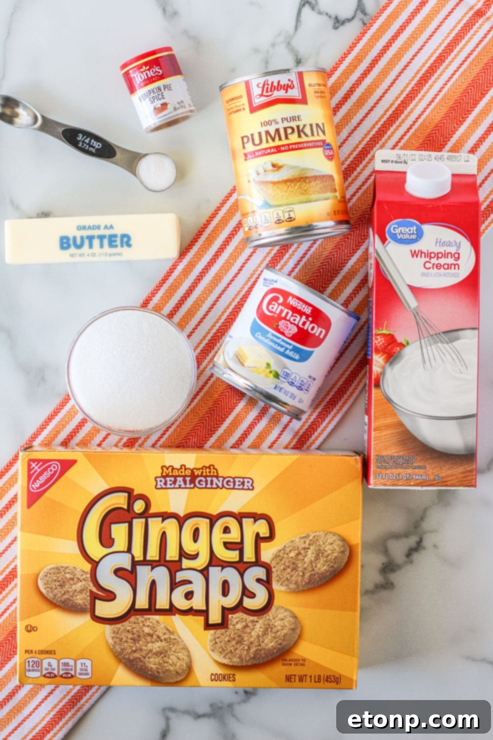 A scoop of homemade gingersnap pumpkin ice cream, showcasing its creamy texture and the subtle specks of spice that promise a flavorful experience.