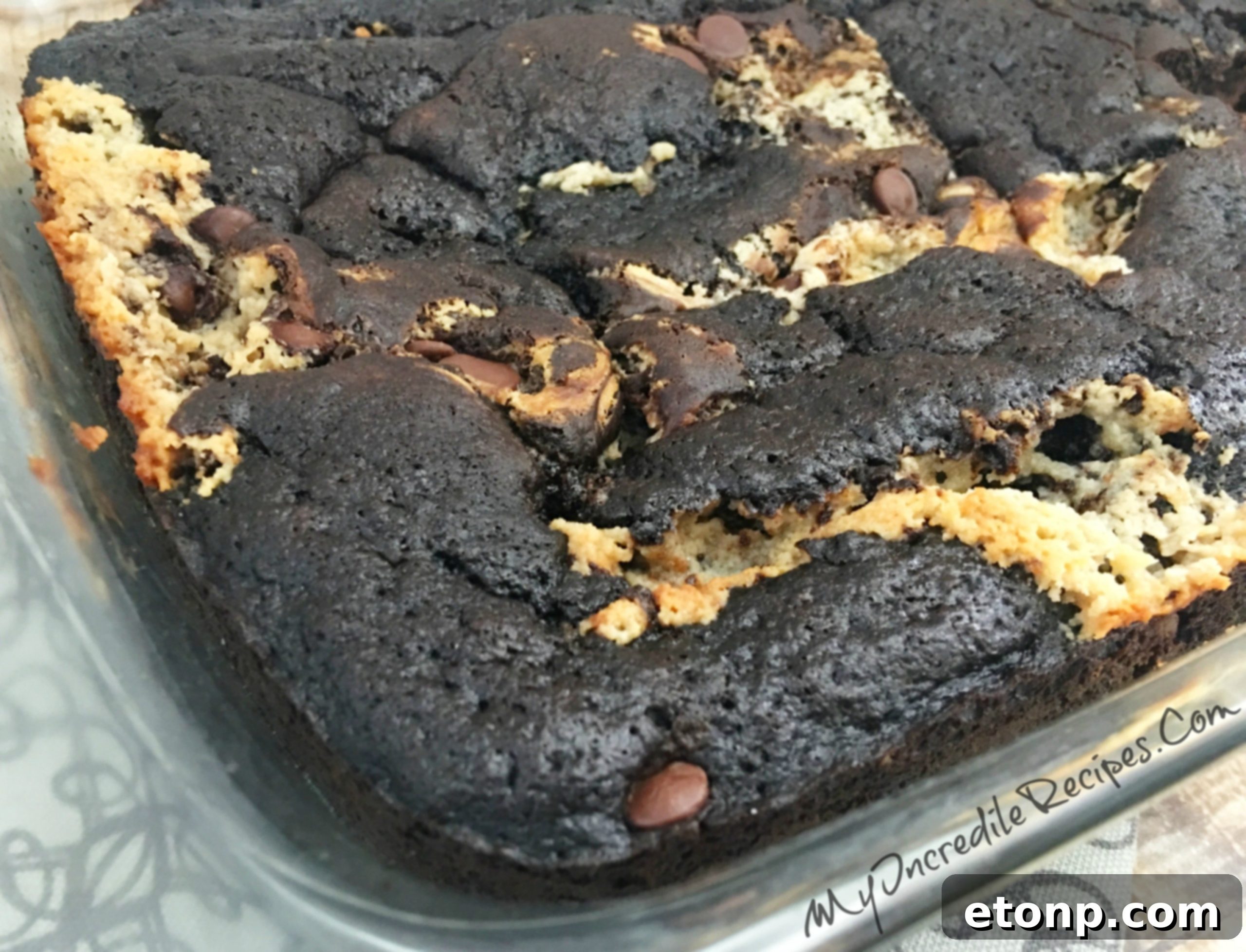 A close-up view of the baked Peanut Butter Earthquake Cake, showing its rich, fudgy interior and textured top