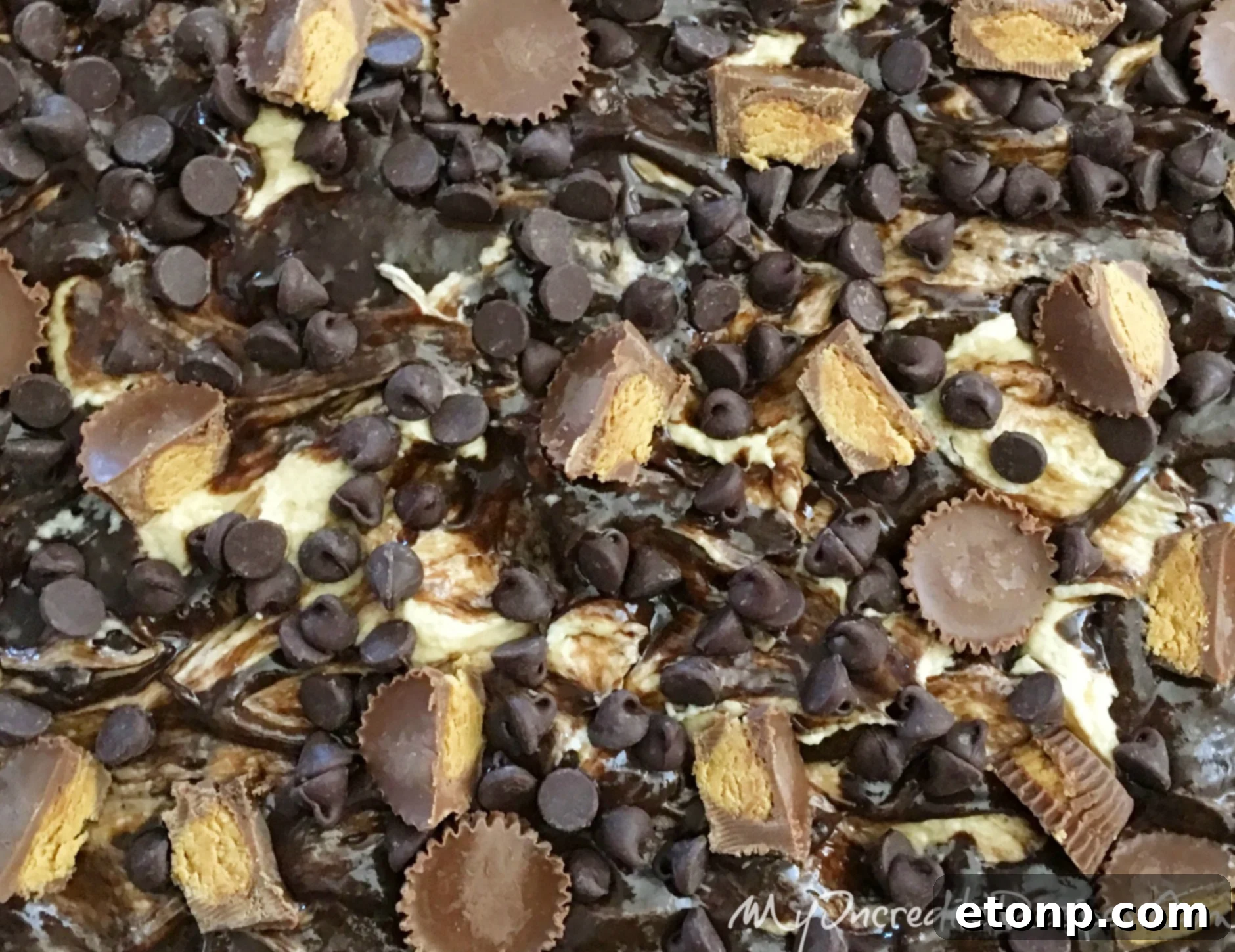Close-up of the chocolate cake batter poured into a baking dish, ready for the peanut butter cream cheese topping