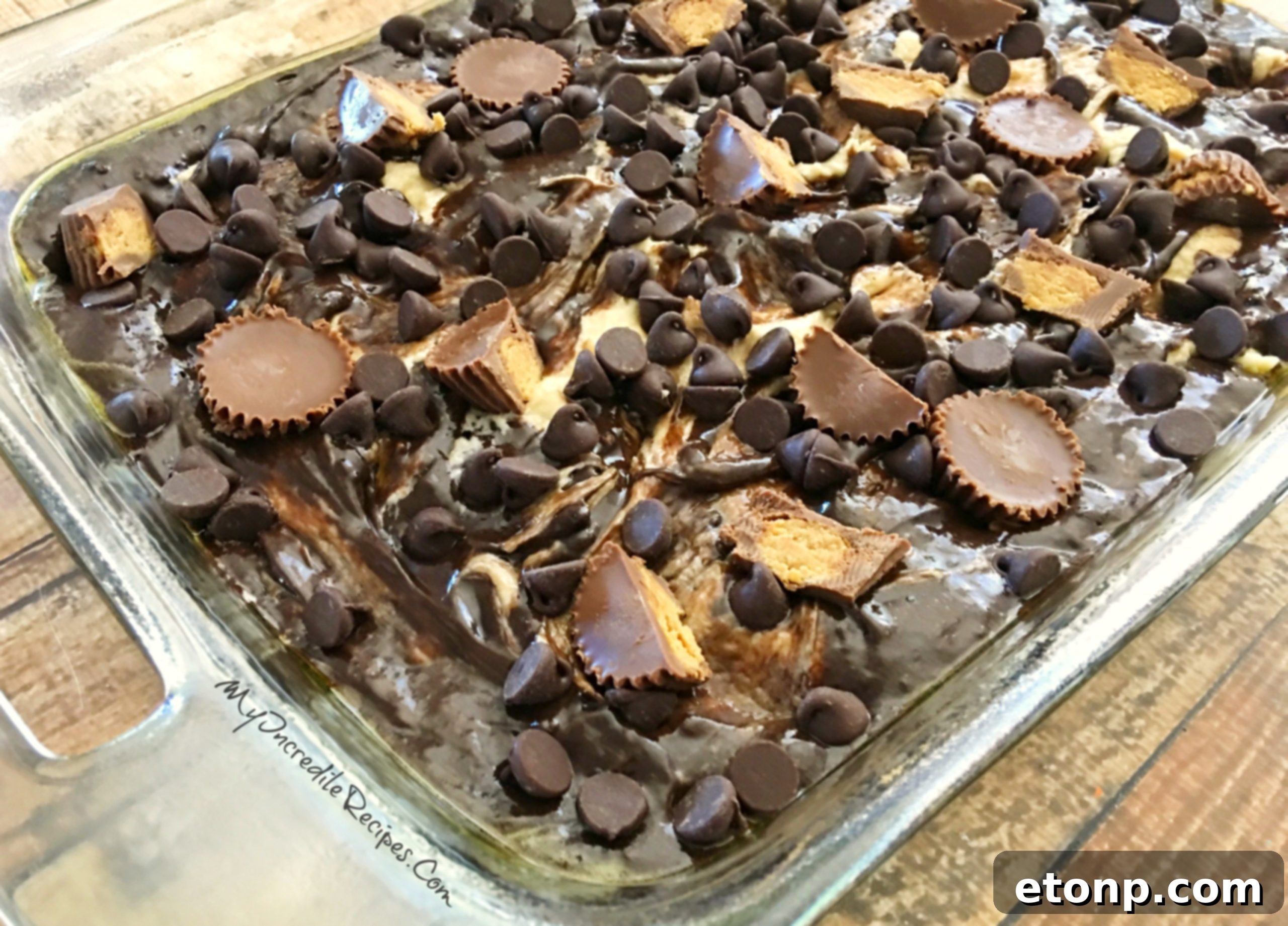 Peanut Butter Earthquake Cake with Reese's peanut butter cups and chocolate chips sprinkled on top before baking