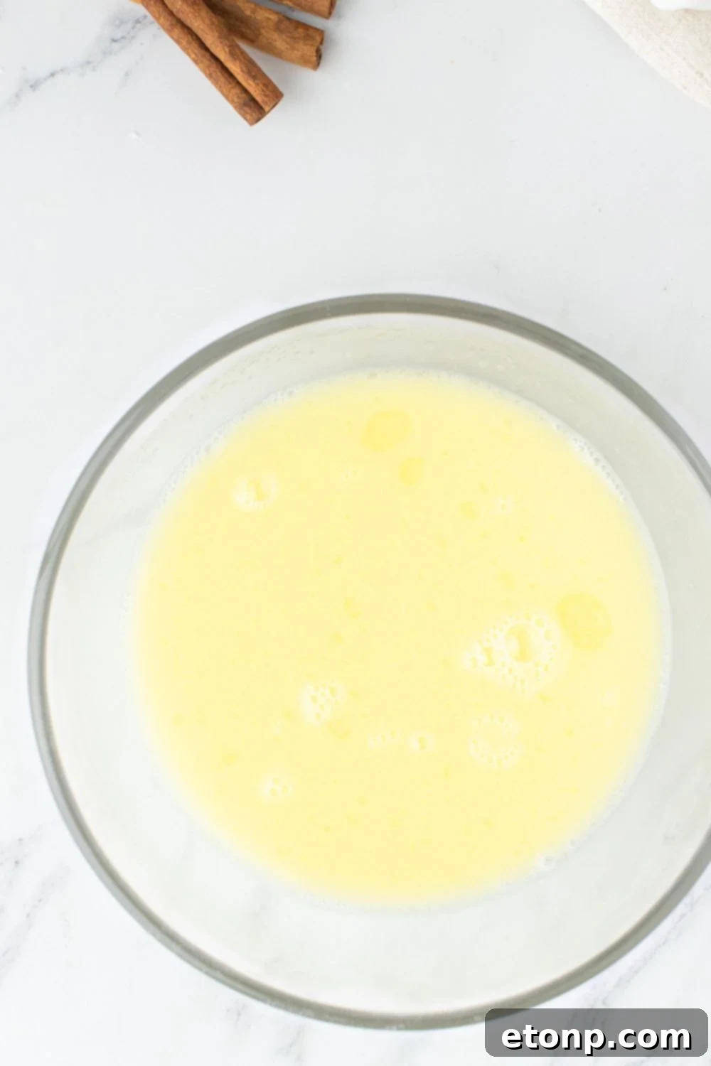 Melted butter, milk, and water mixture in a glass bowl