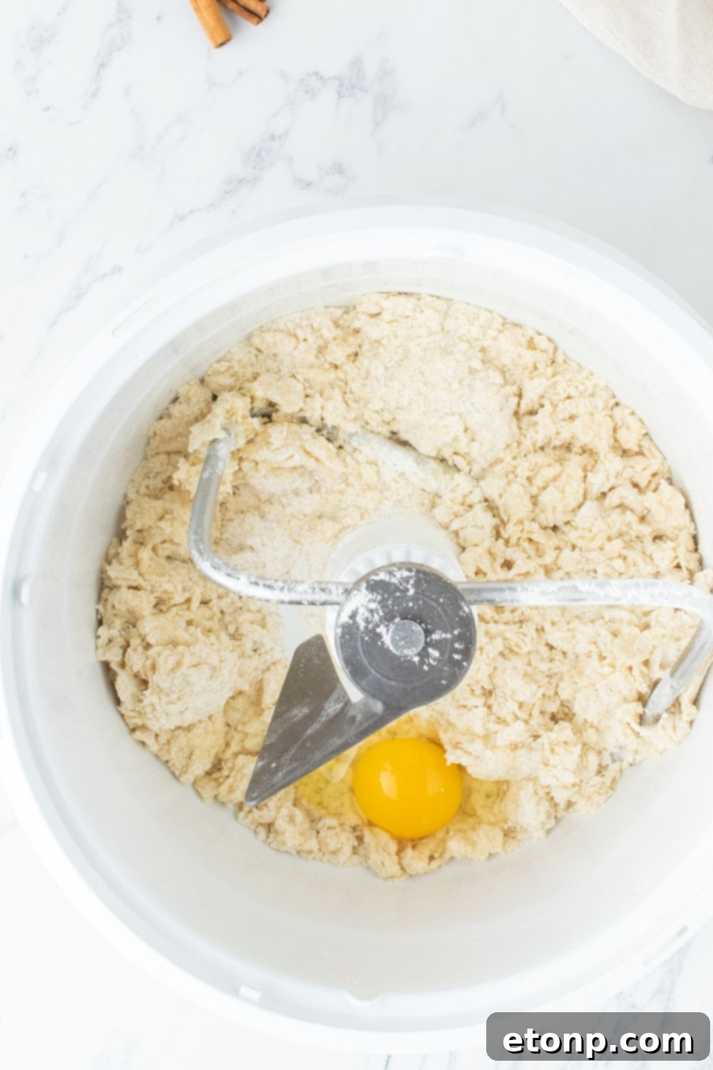 Dry ingredients and an egg in a stand mixer bowl