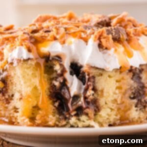 Butterfinger Poke Cake on plate with a bite taken out of it