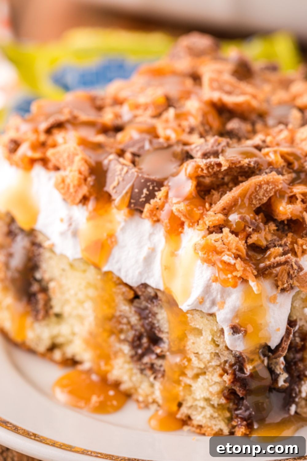 plate with a slice of cake topped with butterfinger pieces