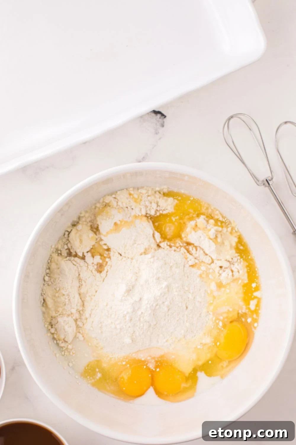 cake batter mixture in a white bowl on table