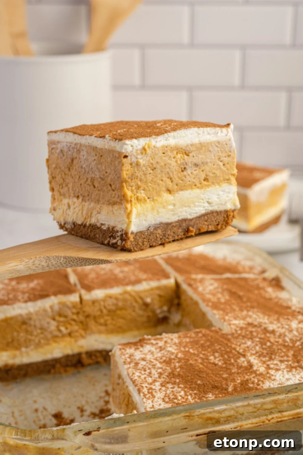 spatula with pumpkin delight and pan below
