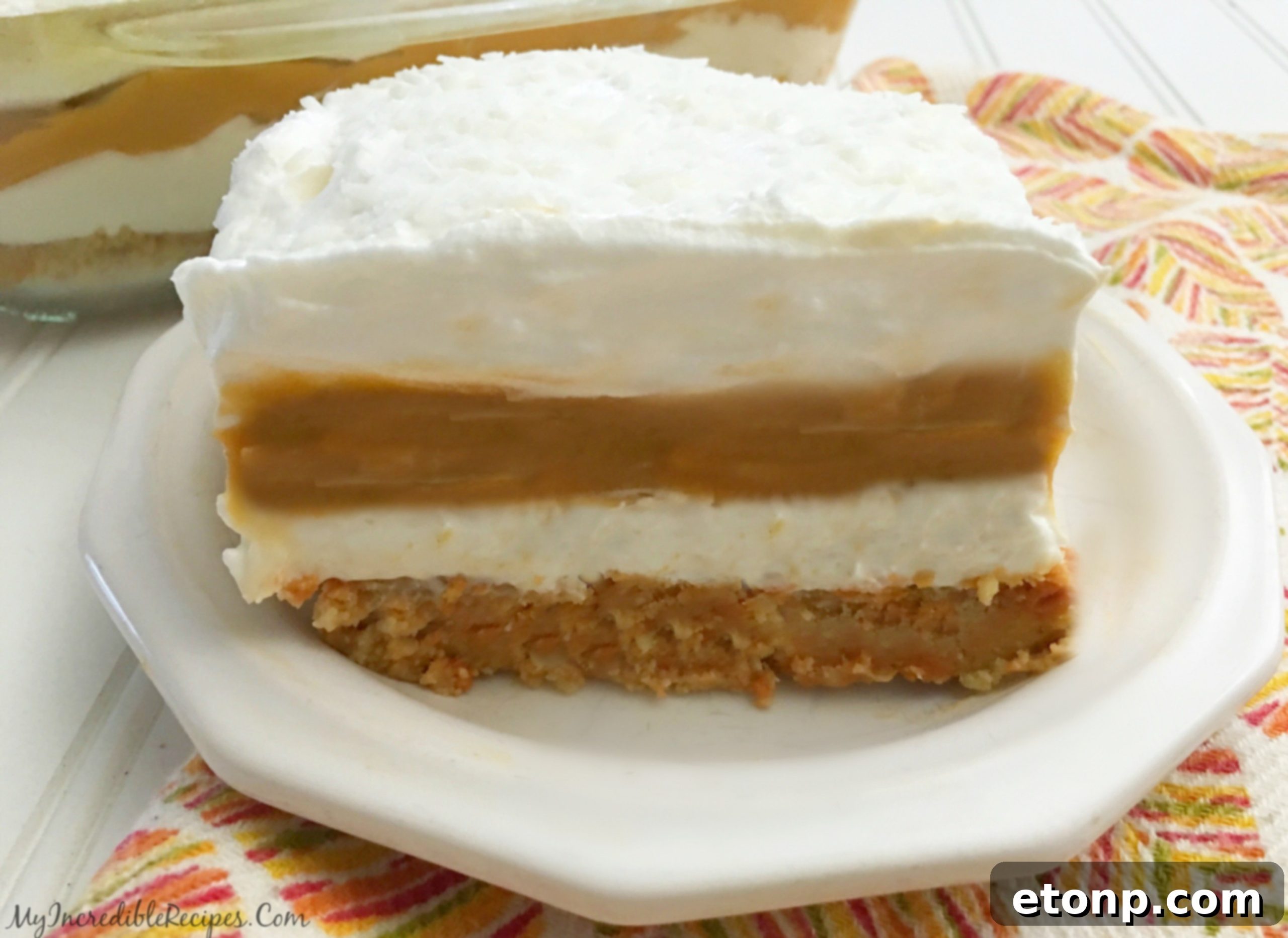 A final full view of the delicious Pumpkin Cheesecake Lasagna with a serving taken out.