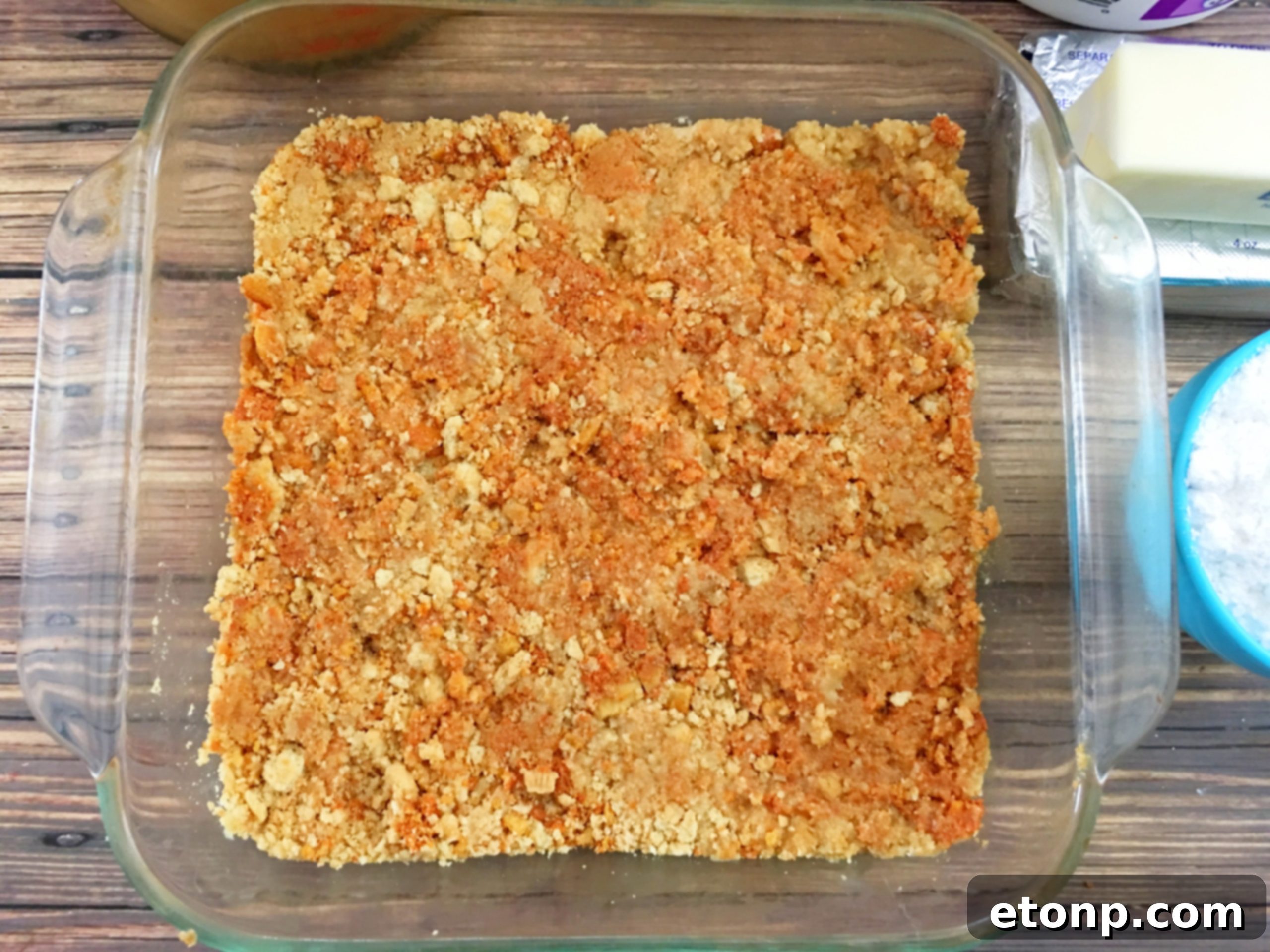Pumpkin spice instant pudding being whisked with milk, creating the flavorful pumpkin layer.
