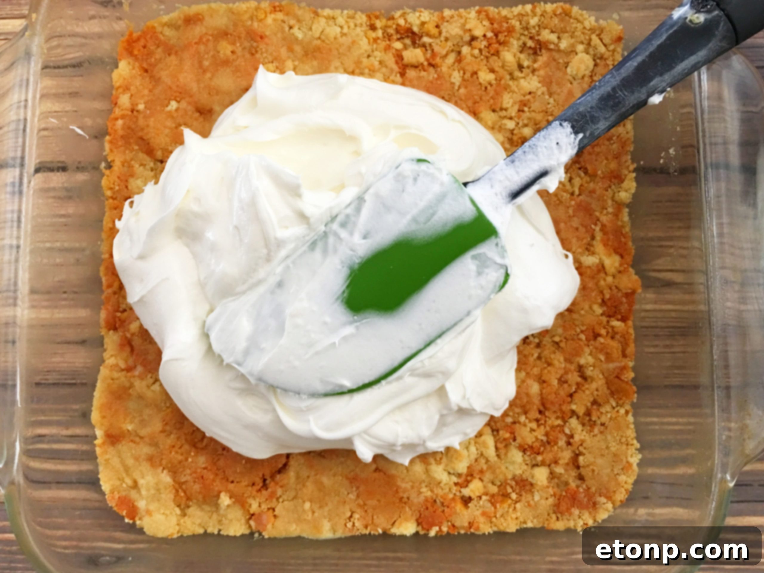 No-bake pumpkin cheesecake lasagna topped with delicate shaved white chocolate.