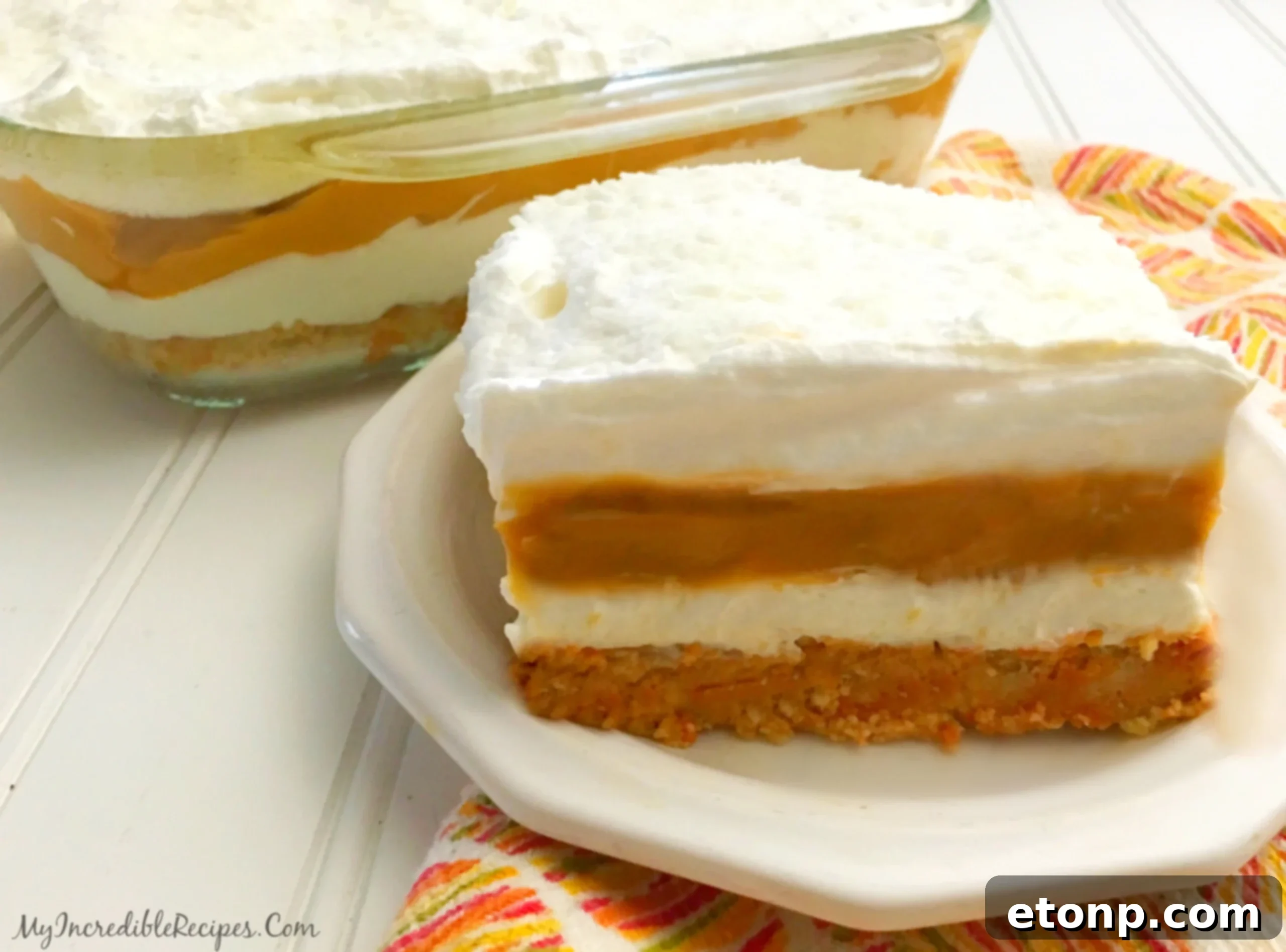 Close-up of a large dish of pumpkin cheesecake lasagna, ready for serving or freezing.