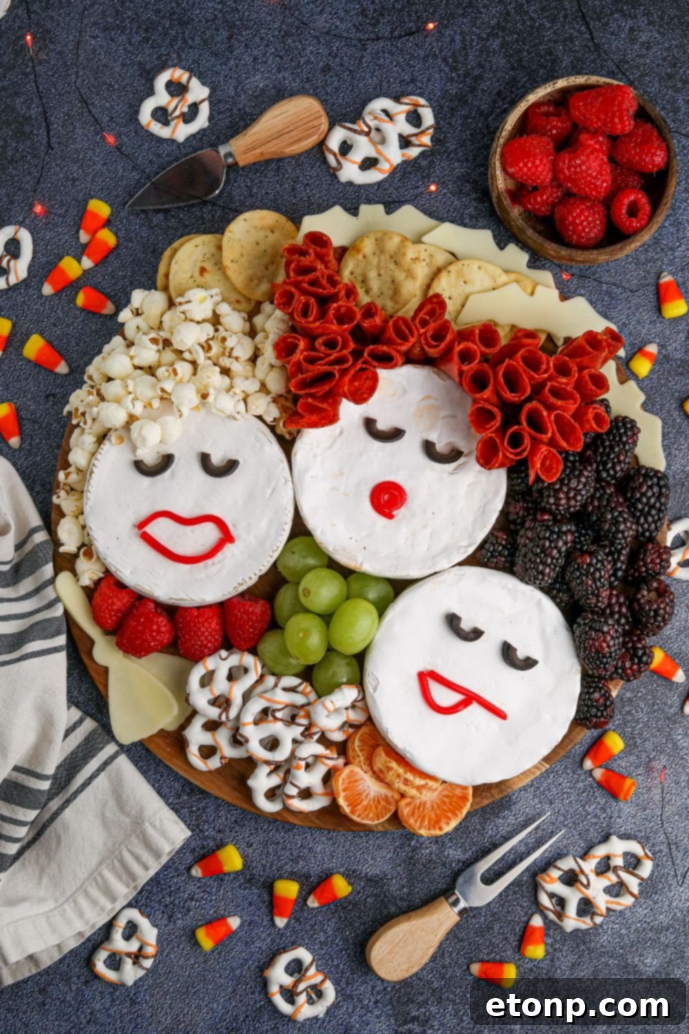 sanderson sisters charcuterie board on table with snack items behind it