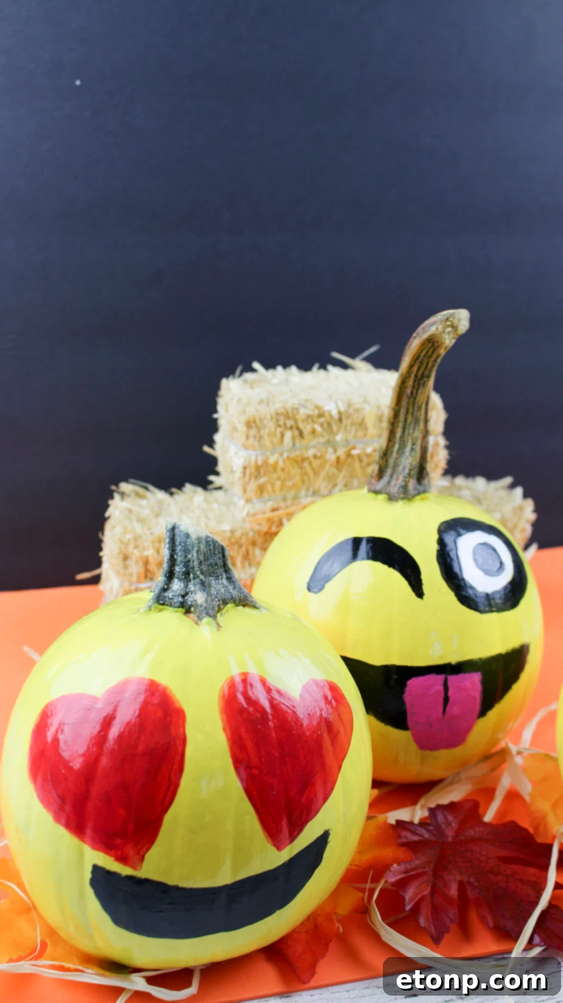 A close-up of the heart-eye emoji pumpkin, showing its charming expression and readiness to be part of any Fall display.