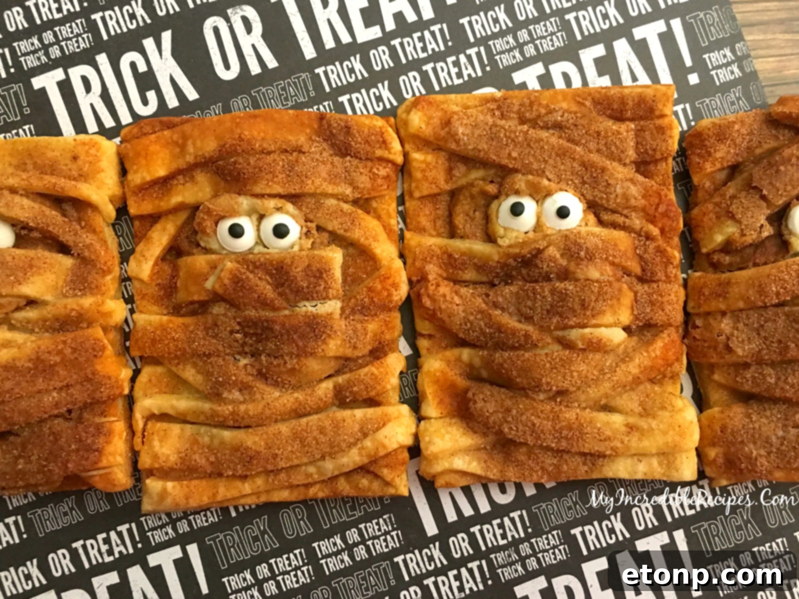 A final shot of the pumpkin cheesecake mummy hand pies, highlighting their appeal.