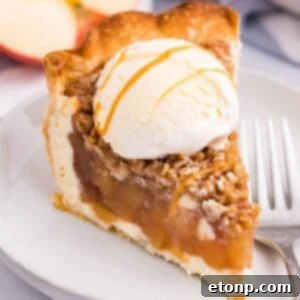 Apple Crumble Cheesecake slice of pie on plate with ice cream on top
