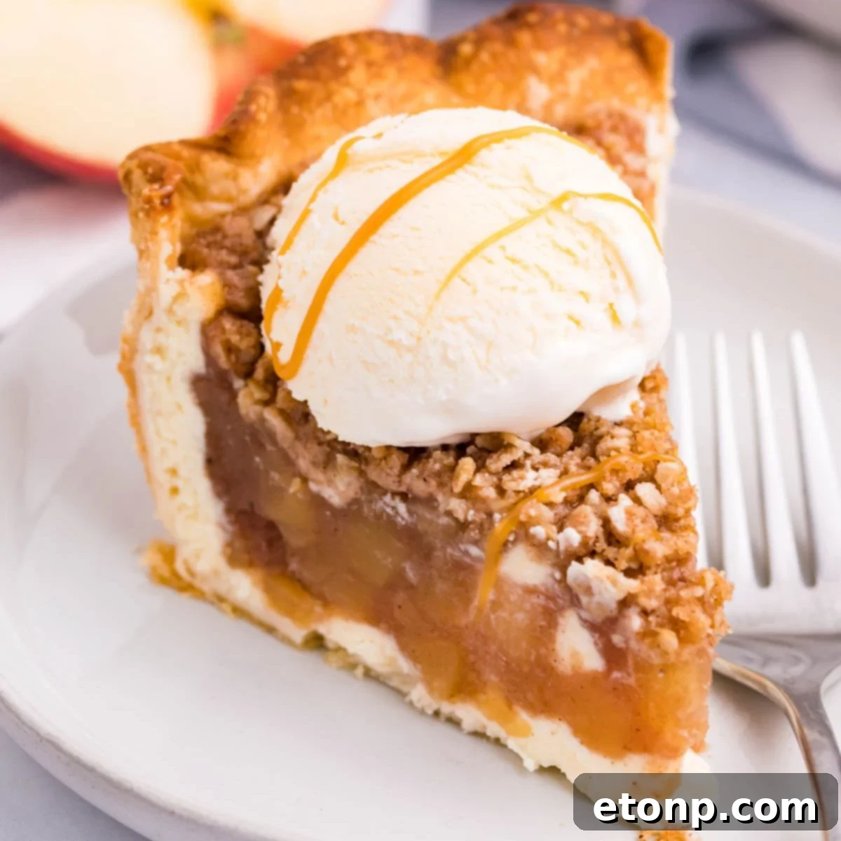 Apple Crumble Cheesecake slice of pie on plate with ice cream on top