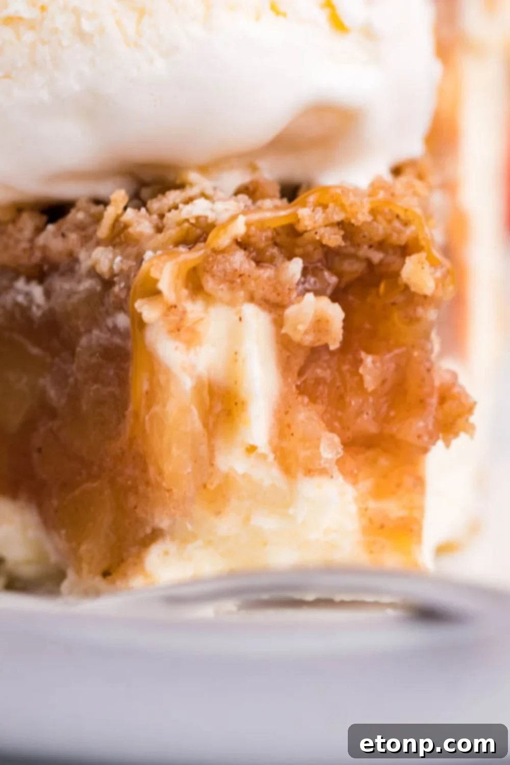 apple crisp cheesecake on plate with bite taken out