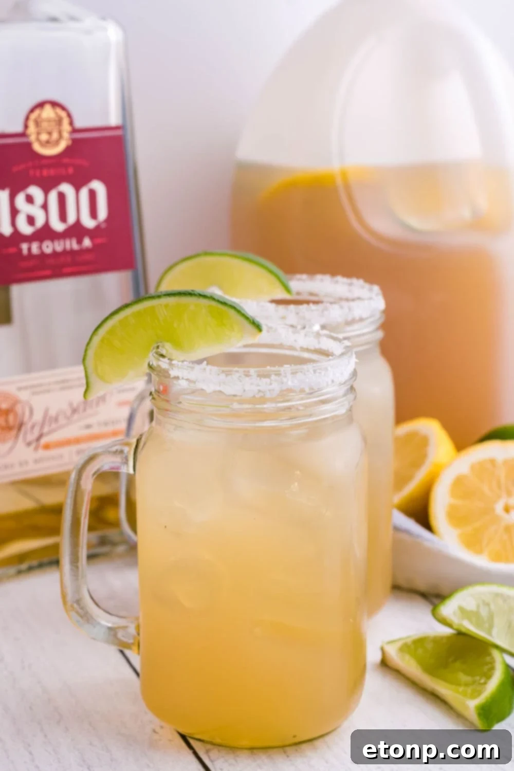 Gallon Margarita served in mason jars, garnished with salt rims and fresh lime wedges