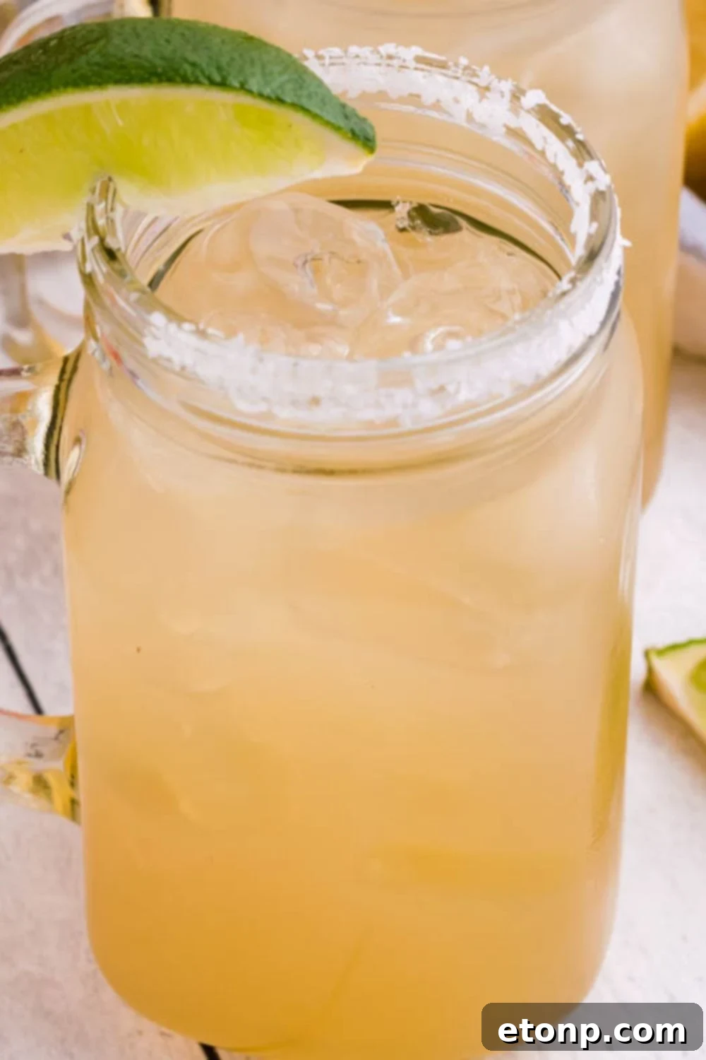 A refreshing classic margarita in a glass with a lime wedge, highlighting the drink's appeal