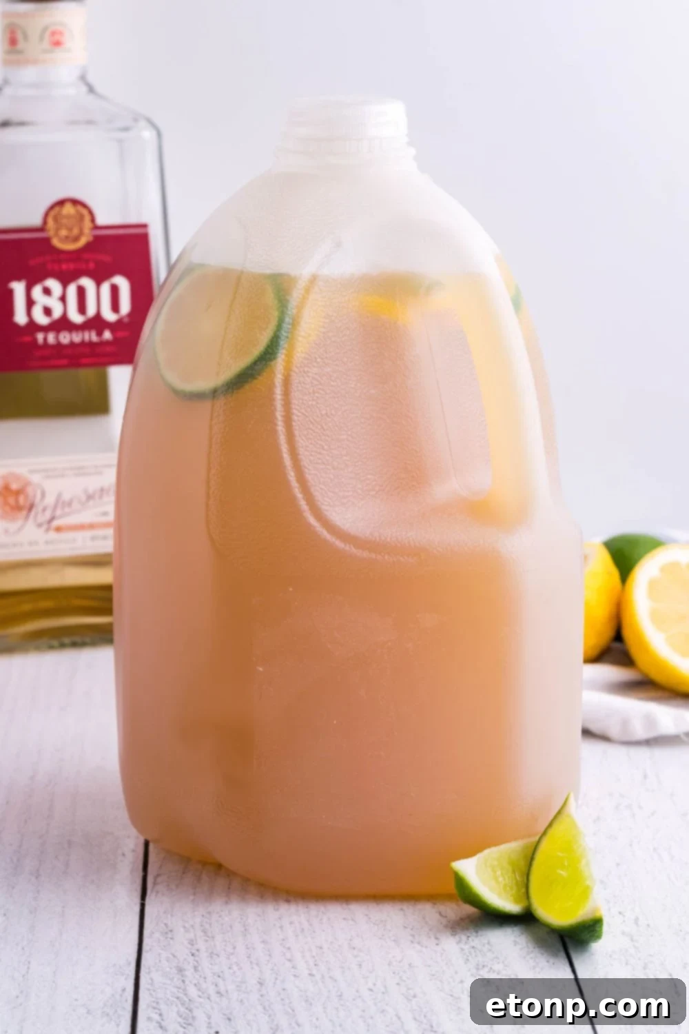 A gallon jug filled with prepared margarita mixture, showcasing the large batch convenience