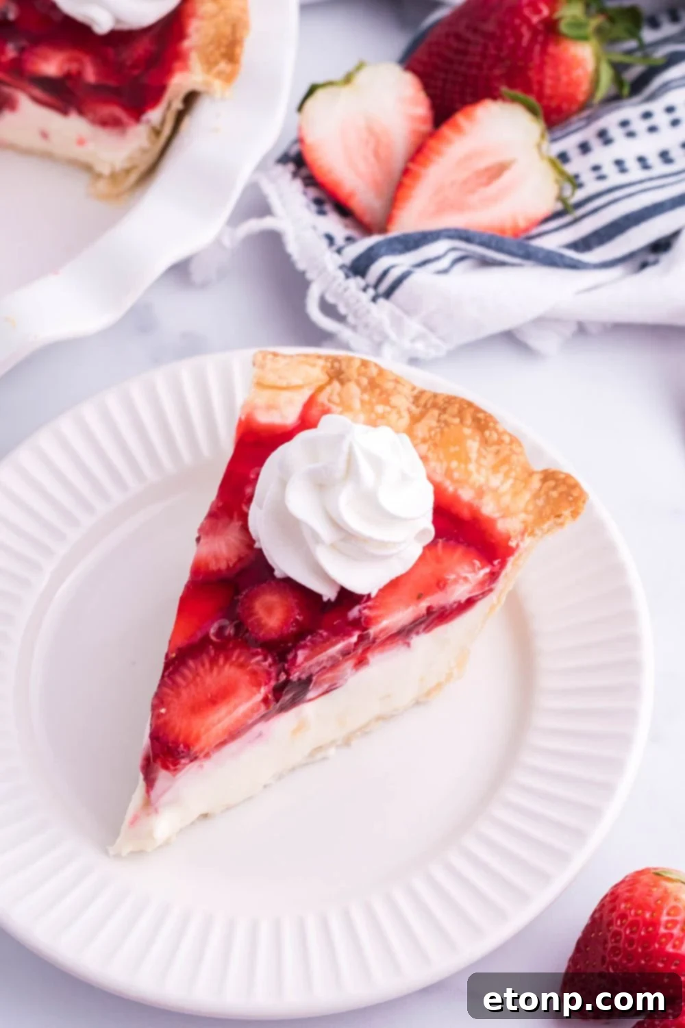strawberry cheesecake pie sliced on plate