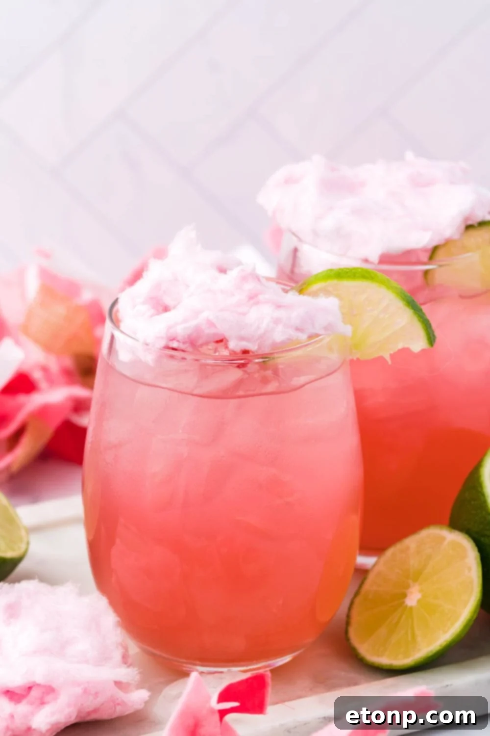 cocktail with cotton candy on top and decorations around it for staging