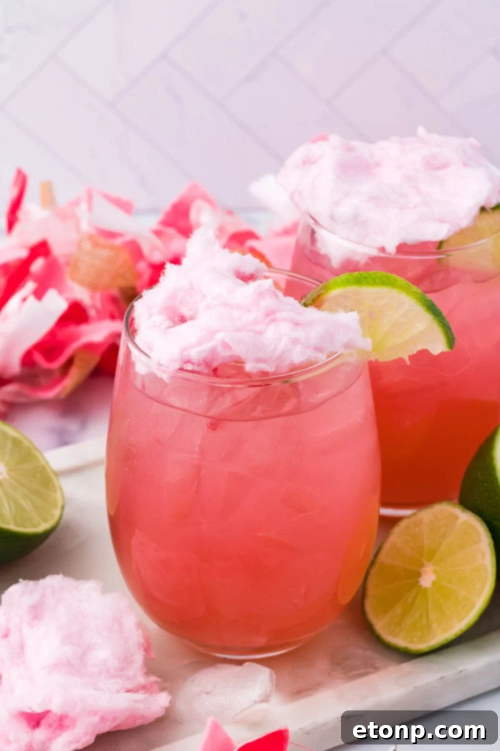 candy margaritas on table with lime wedges on table