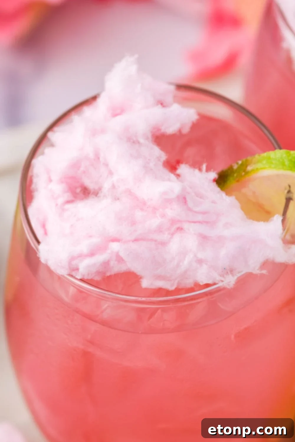 close up of a cotton candy drink with cotton candy sitting on top