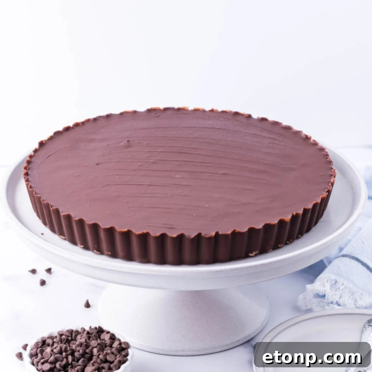 Giant Reese's Cup Pie on a serving tray, showcasing its impressive size and classic ridges