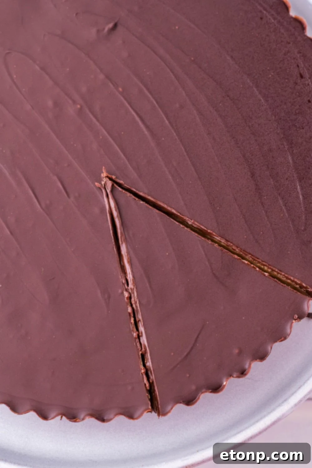 A whole Giant Reese's Cup Pie presented beautifully, showcasing its perfect ridges and inviting appearance