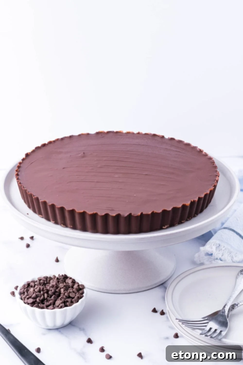 A Giant Reese's Cup Pie resting majestically on a serving tray, ready to be enjoyed